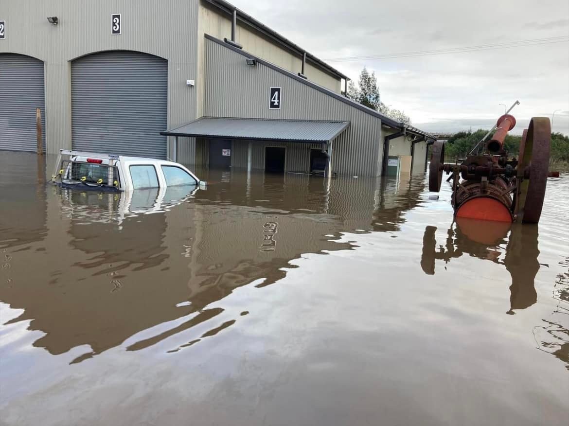 Volunteers pull on their boots to mop up after floodwater inundated